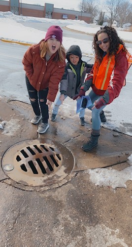 Photo of volunteers around storm drain