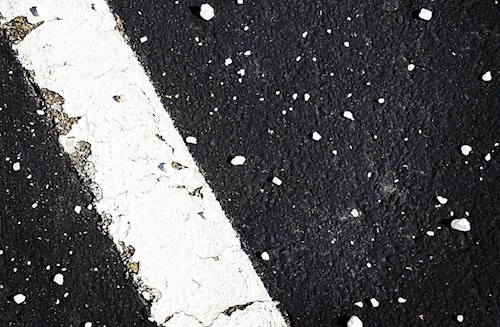 Photo of pavement with appropriately-spaced granules of salt 